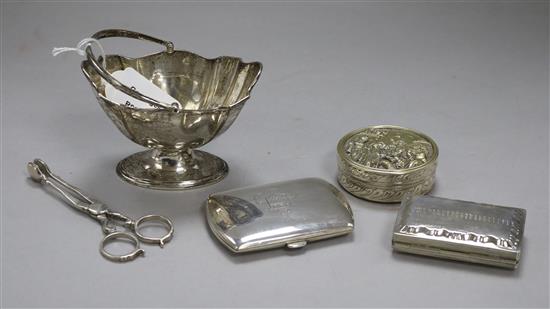 An Edwardian silver sugar basket, a later silver cigarette case, a pair of Britannia standard silver sugar nips and two boxes.